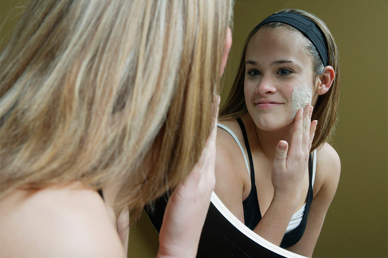 teen applying facial cream