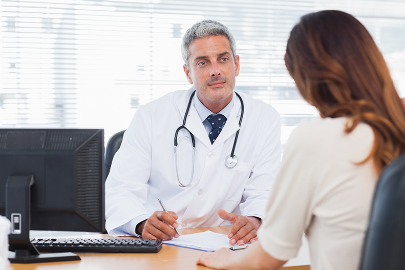 doctor talking to female patient