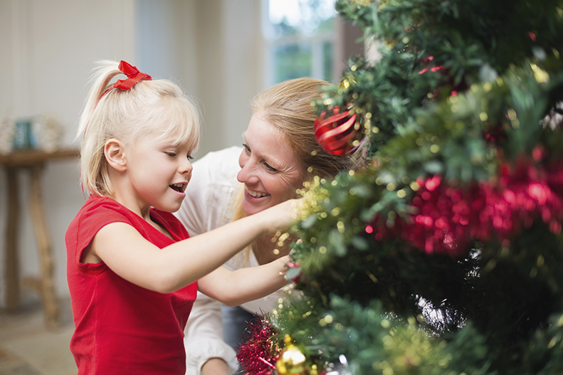 girl and mother by Christmas tree