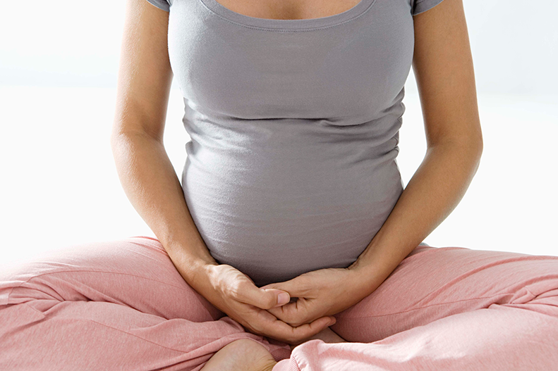 pregnant woman with legs crossed