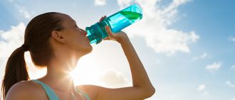 Woman drinking water to show the importance of hydration for athletes