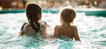 Children splashing in a pool.