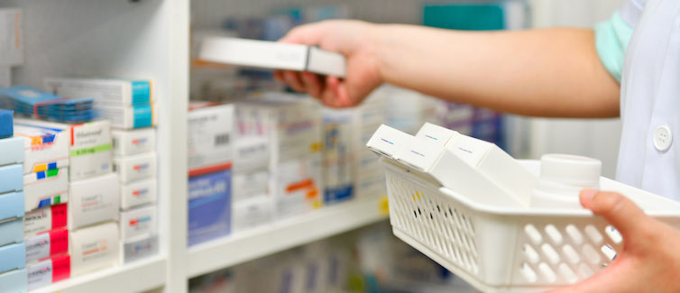 Pharmacist filling prescription in pharmacy store